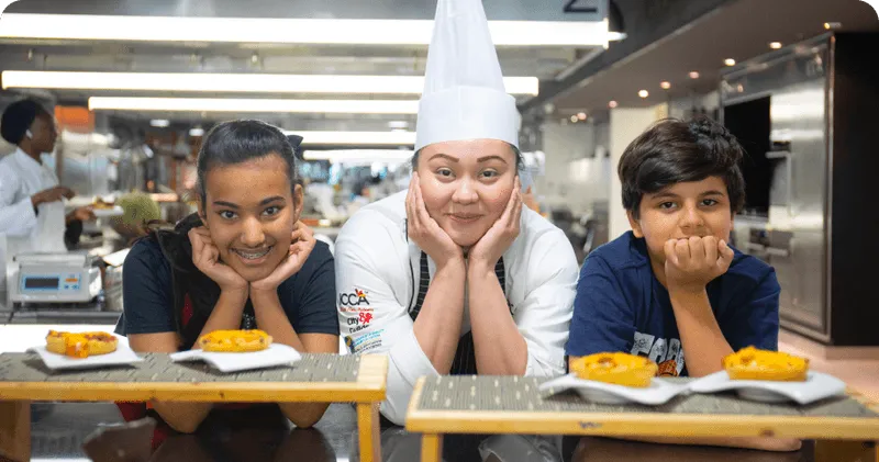 children's and team member watching recipe and smiling
