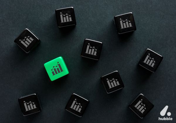 Black and green cubes with growth chart icons, representing the role of AI and data analytics in enhancing sales performance.