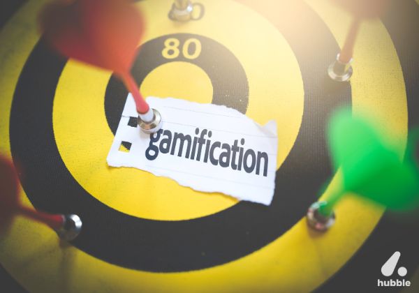 Dartboard with multiple darts and the word "gamification," symbolizing the role of gamification in customer loyalty and engagement.