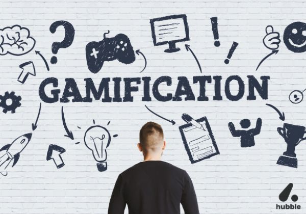 Man looking at a wall with "Gamification" and related icons, symbolizing its role in sales performance and training
