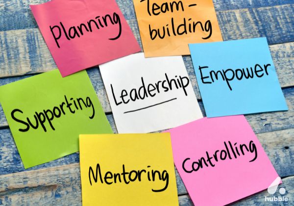 Colorful sticky notes with leadership-related words like planning, mentoring, and empowerment, representing key aspects of employee retention.