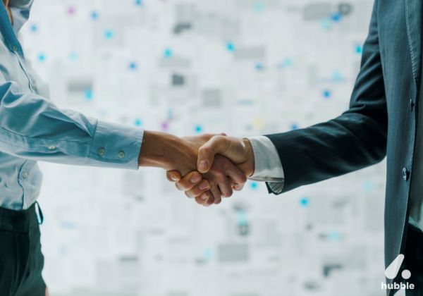 Two business professionals shaking hands, symbolizing successful engagement and retention strategies for channel partners.