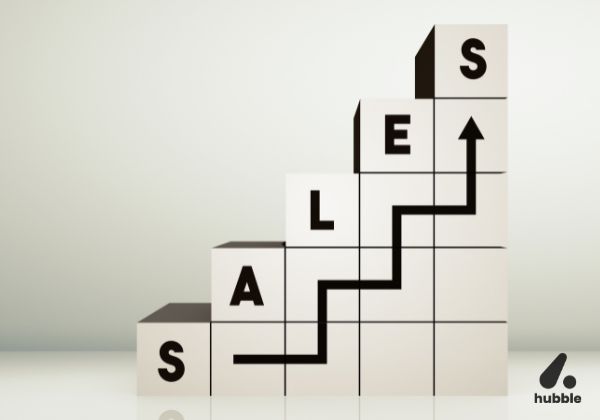 Stacked blocks spelling "SALES" with an upward arrow, symbolizing growth through data-driven insights in channel sales performance.