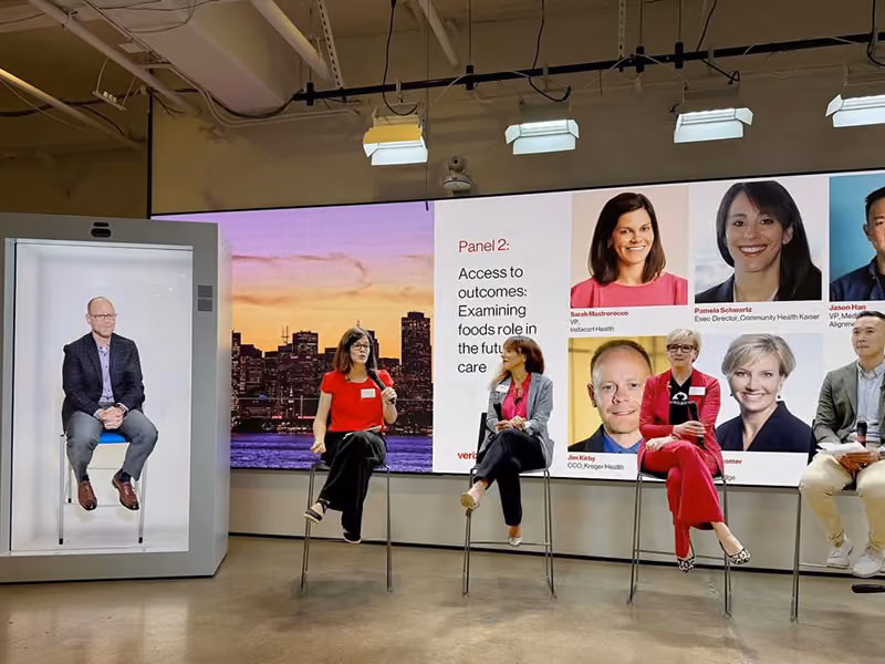 HoloBox911 hologram delivering a leadership message on a corporate video wall