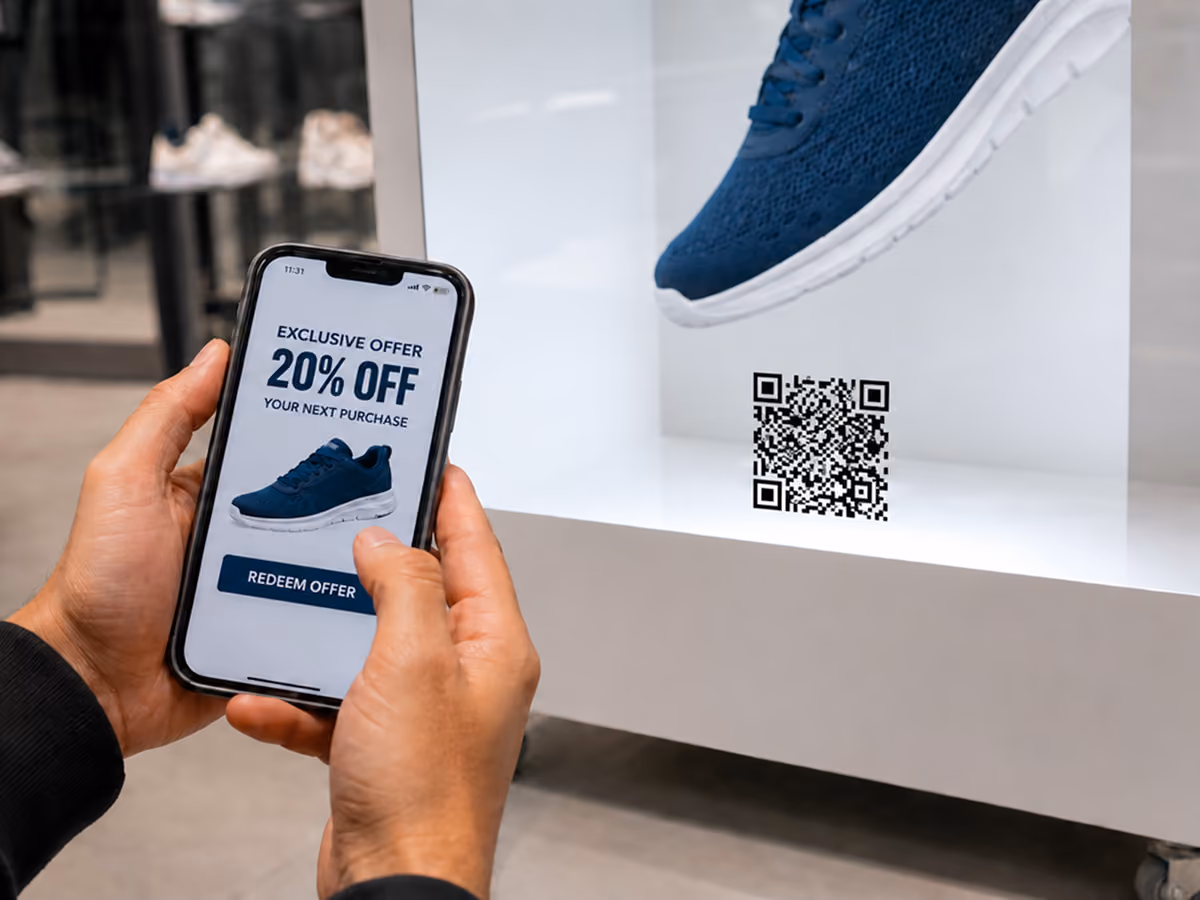 Customer scanning a QR code on a life-size HoloBox 3D footwear display to access product details and exclusive offers in a retail store.