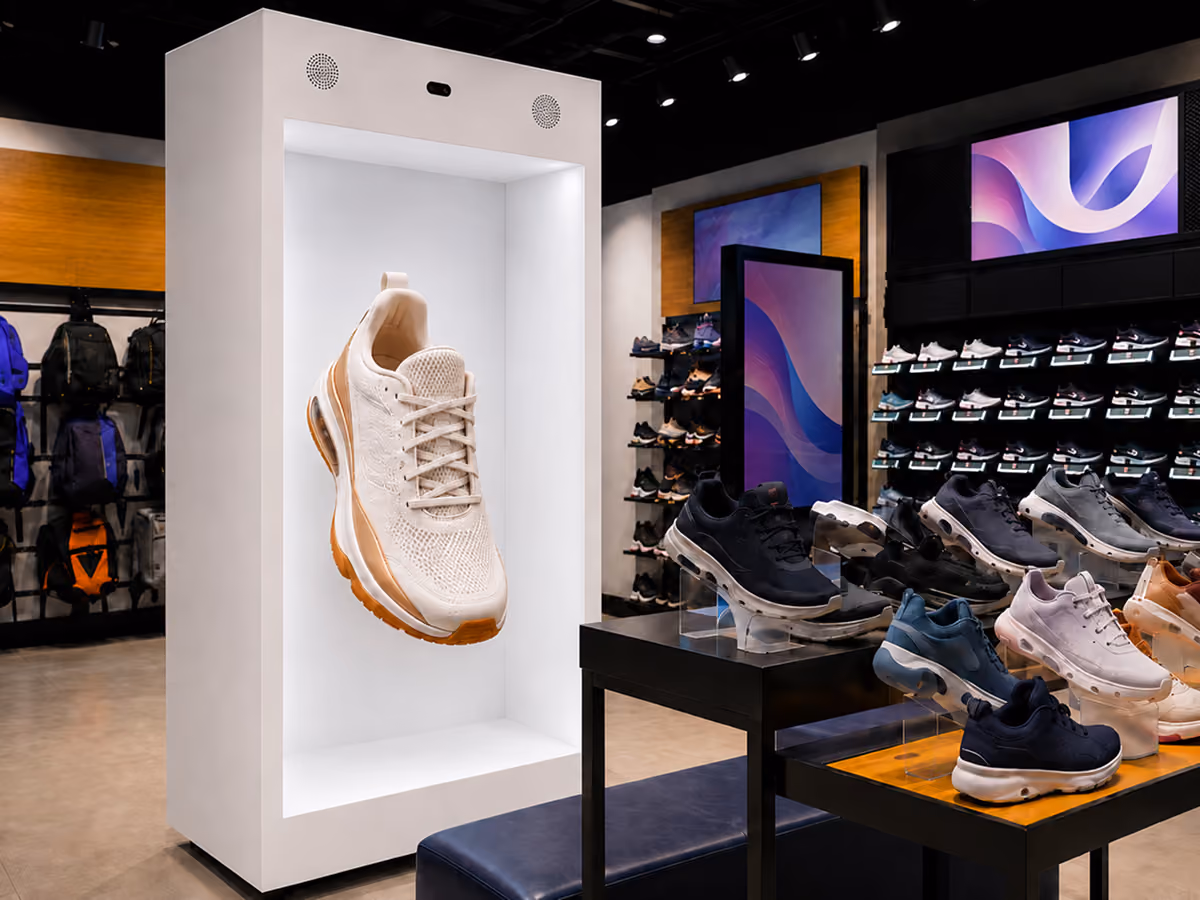 Life-size HoloBox displaying a 3D holographic sneaker inside a retail footwear store, creating an interactive shopping experience for customers.