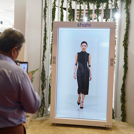 HoloBox911 displaying a life-size holographic fashion garment at the Shahi Exports booth during Bharat Tex, showcasing immersive retail visual merchandising.
