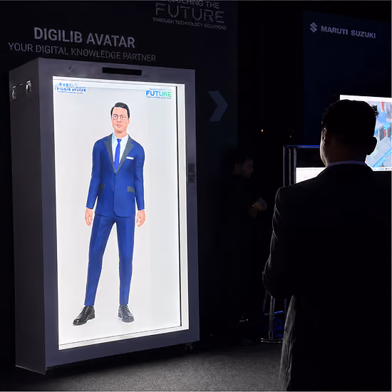 Visitors interacting with a life-size AI avatar inside a HoloBox911 hologram display at the Maruti Suzuki Vendor Conference, demonstrating immersive vendor engagement.