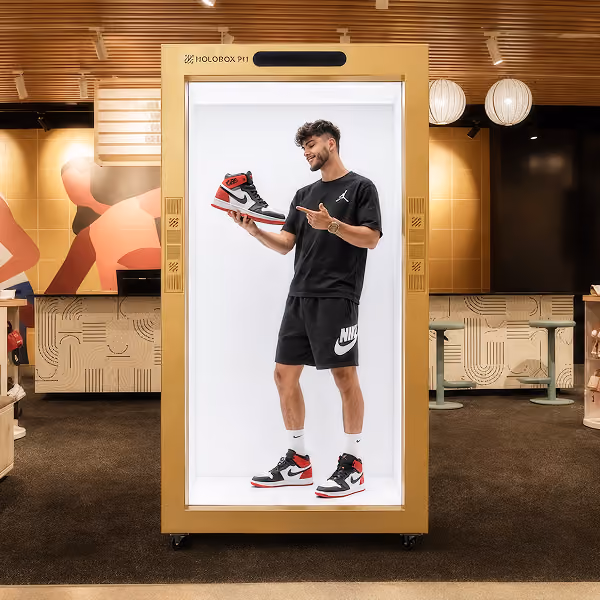 AI retail assistant hologram helping shoppers inside a mall on a HoloBox display