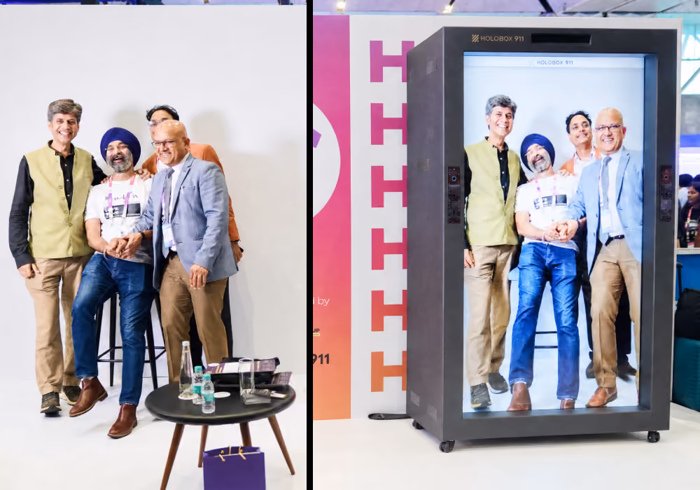 People interacting with a life-size holographic person during a live HoloBox presentation