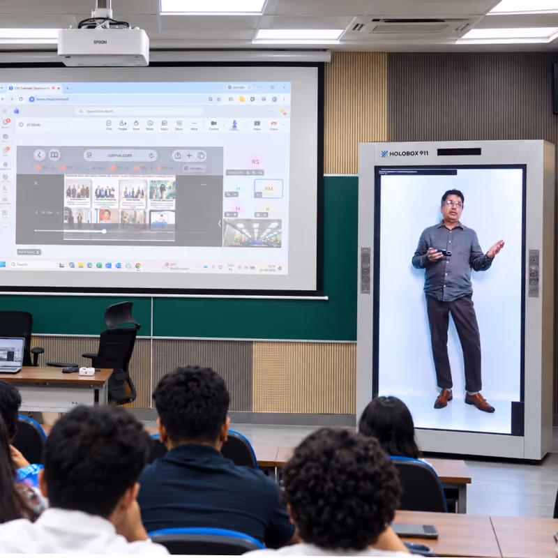 Hologram presenter leading a training seminar in front of a seated audience