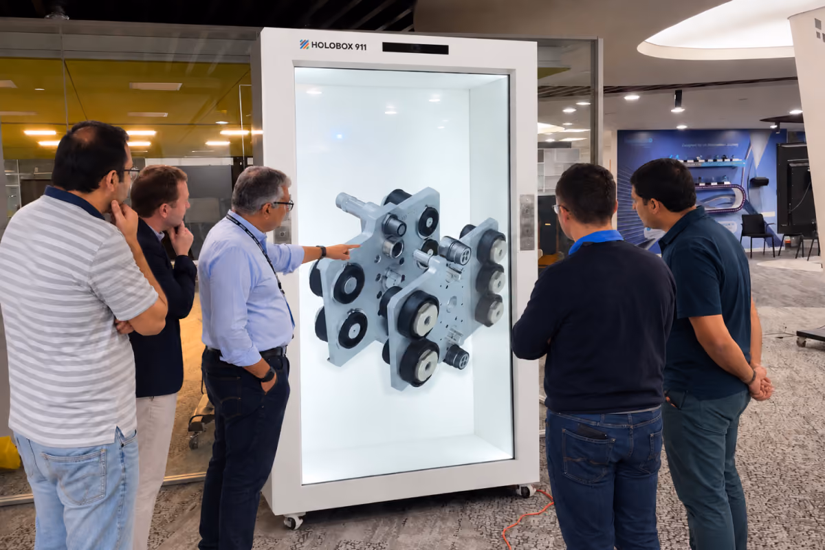 Visitors viewing a 360-degree 3D product hologram inside HoloBox911