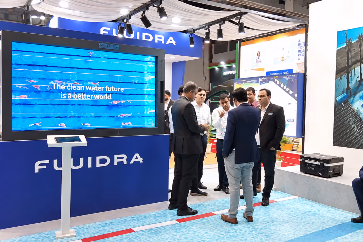 Buyers in conversation beside the HoloBox911 display at SFI Expo 2026