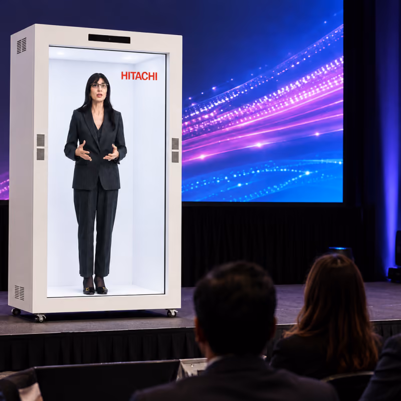 Seated delegates watching the holographic keynote on the main stage at the Hitachi corporate event in New Delhi