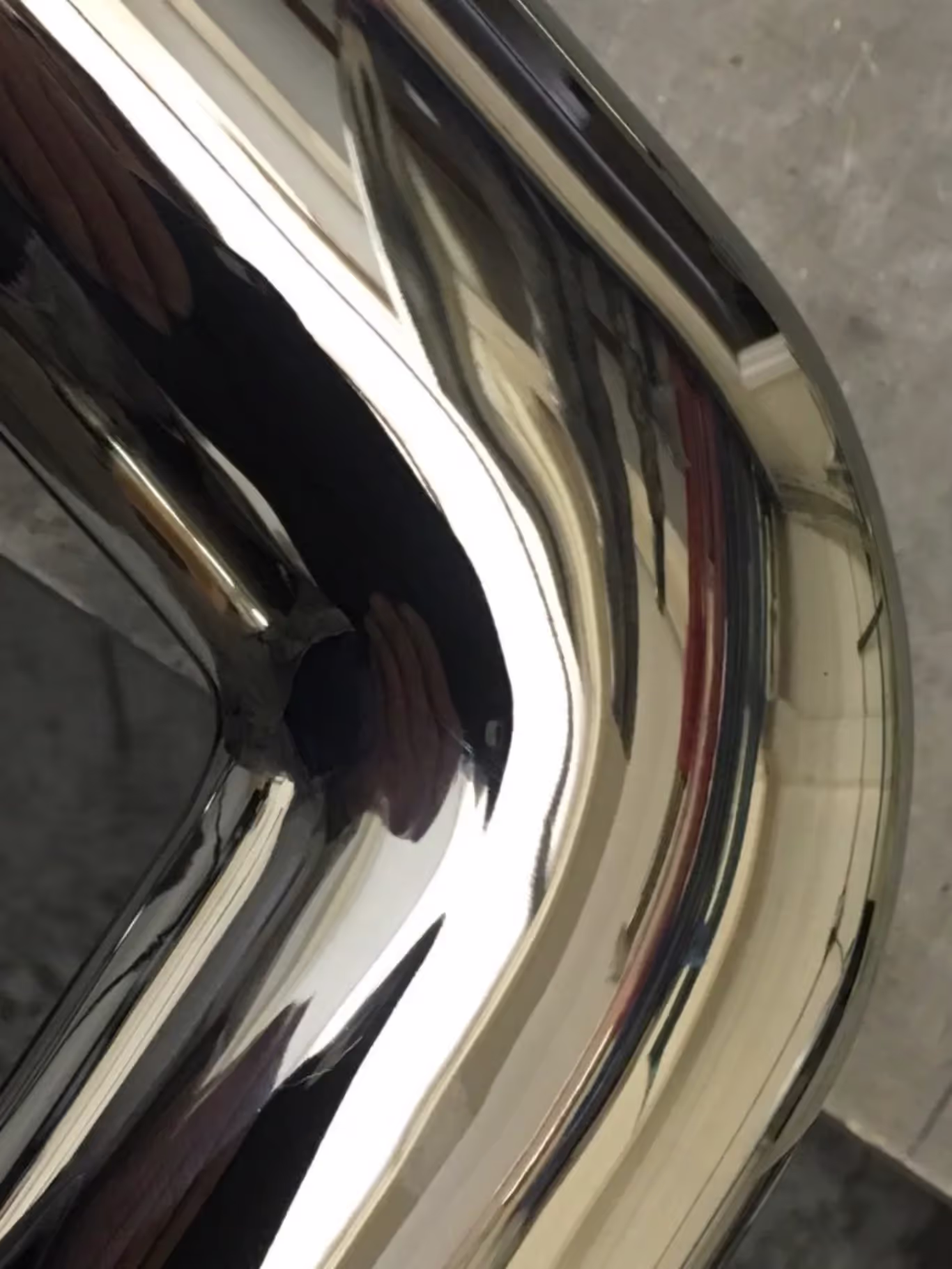 close up of stainless steel oval tube joiner with mirror finish