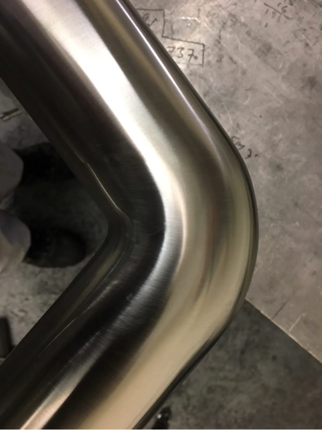 close up of stainless steel oval tube joiner with brushed finish