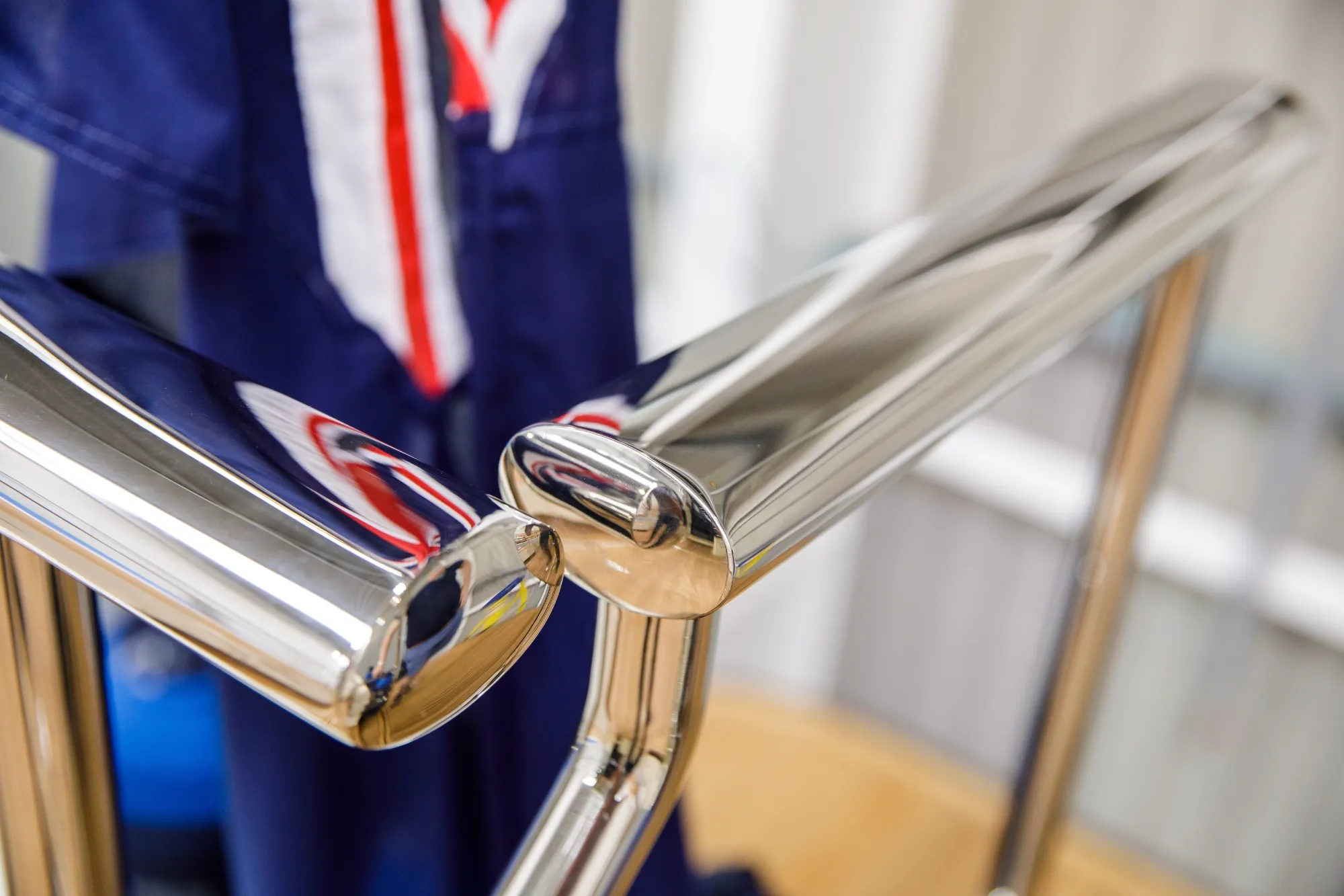 Oval shaped tubing with a mirrored finish being used as a handrail on a boat