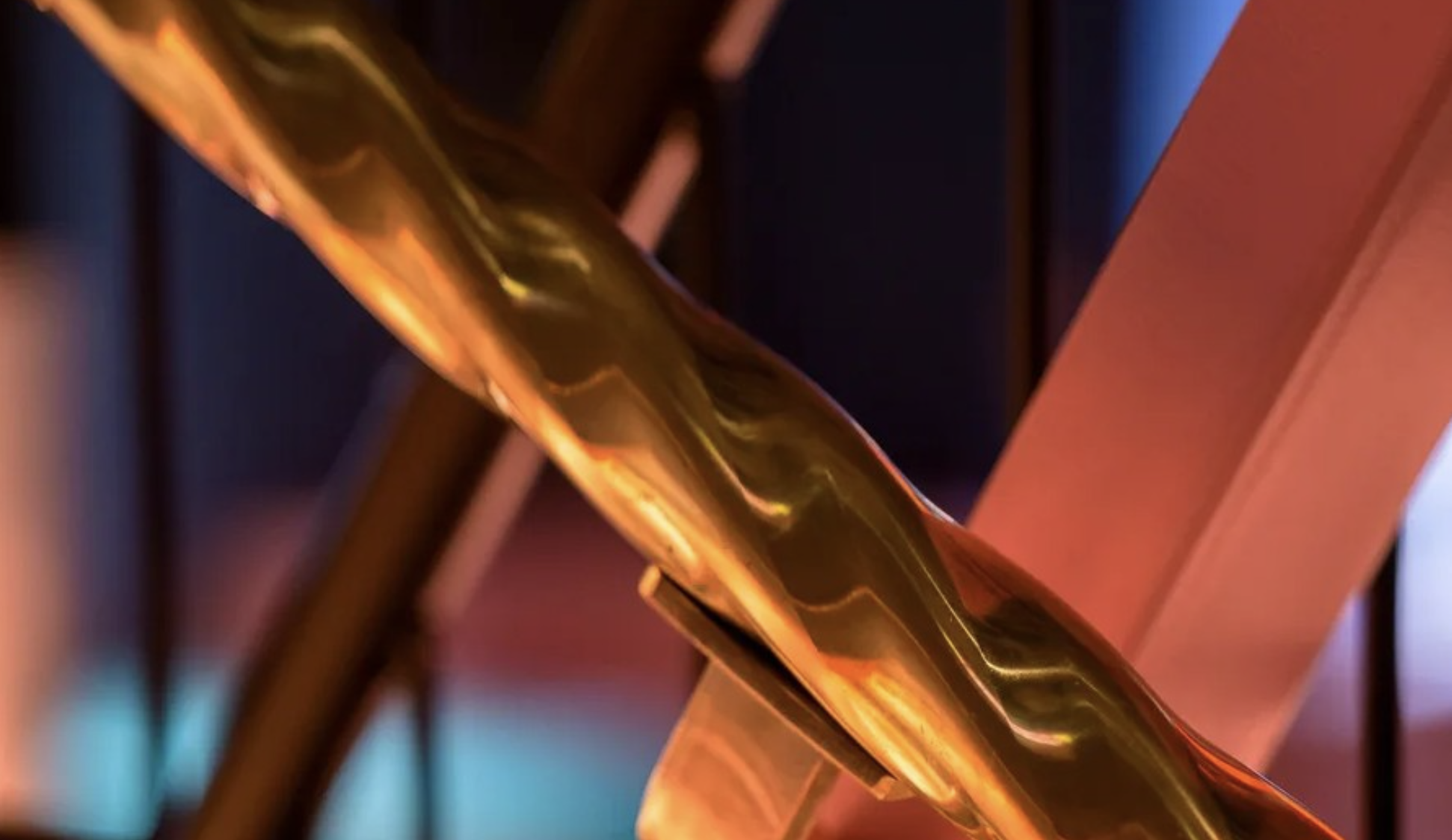Twisted square brass tube handrail for a staircase adds carousel charm to a venue