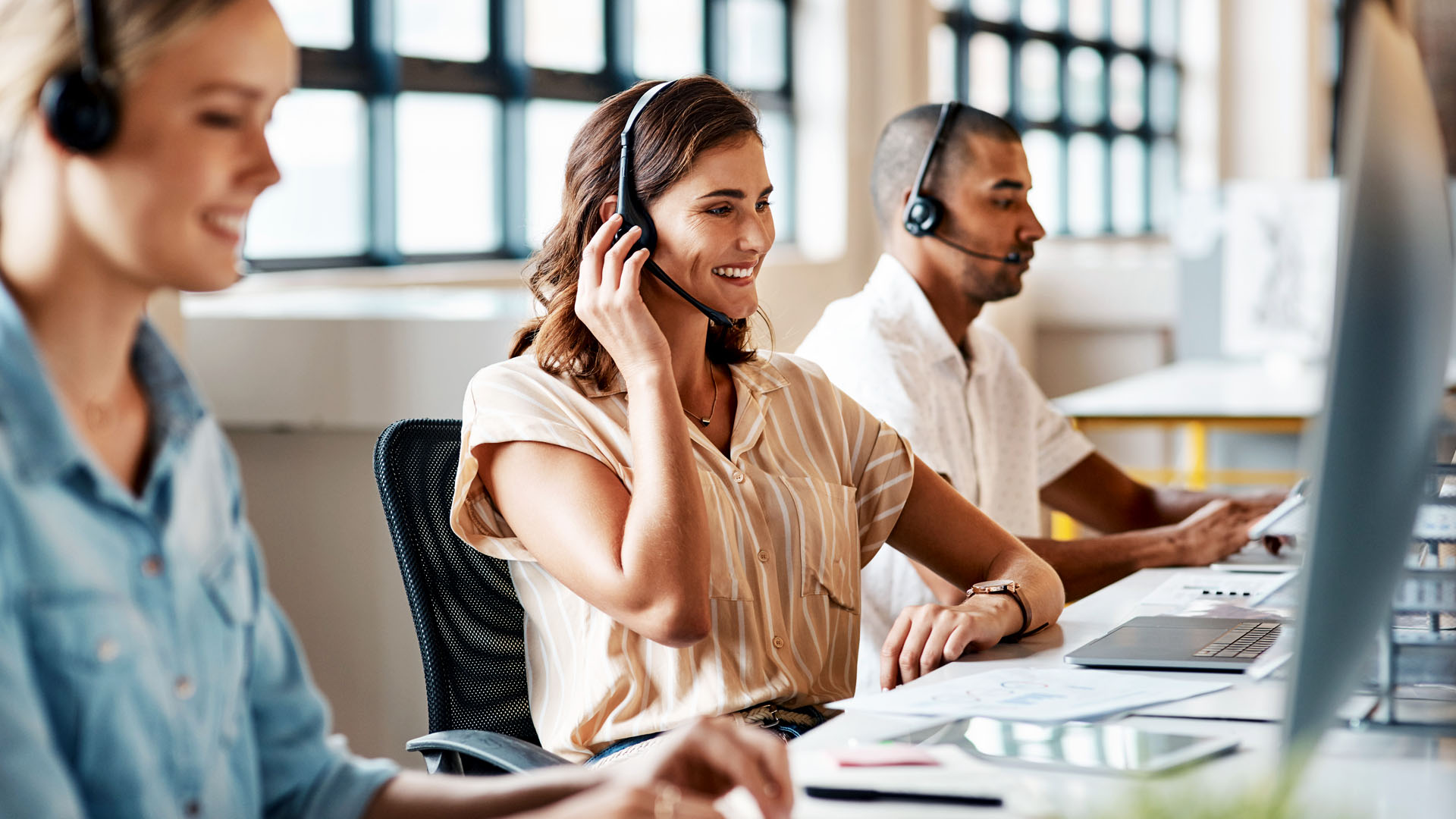 Customer service team with headsets handling requests