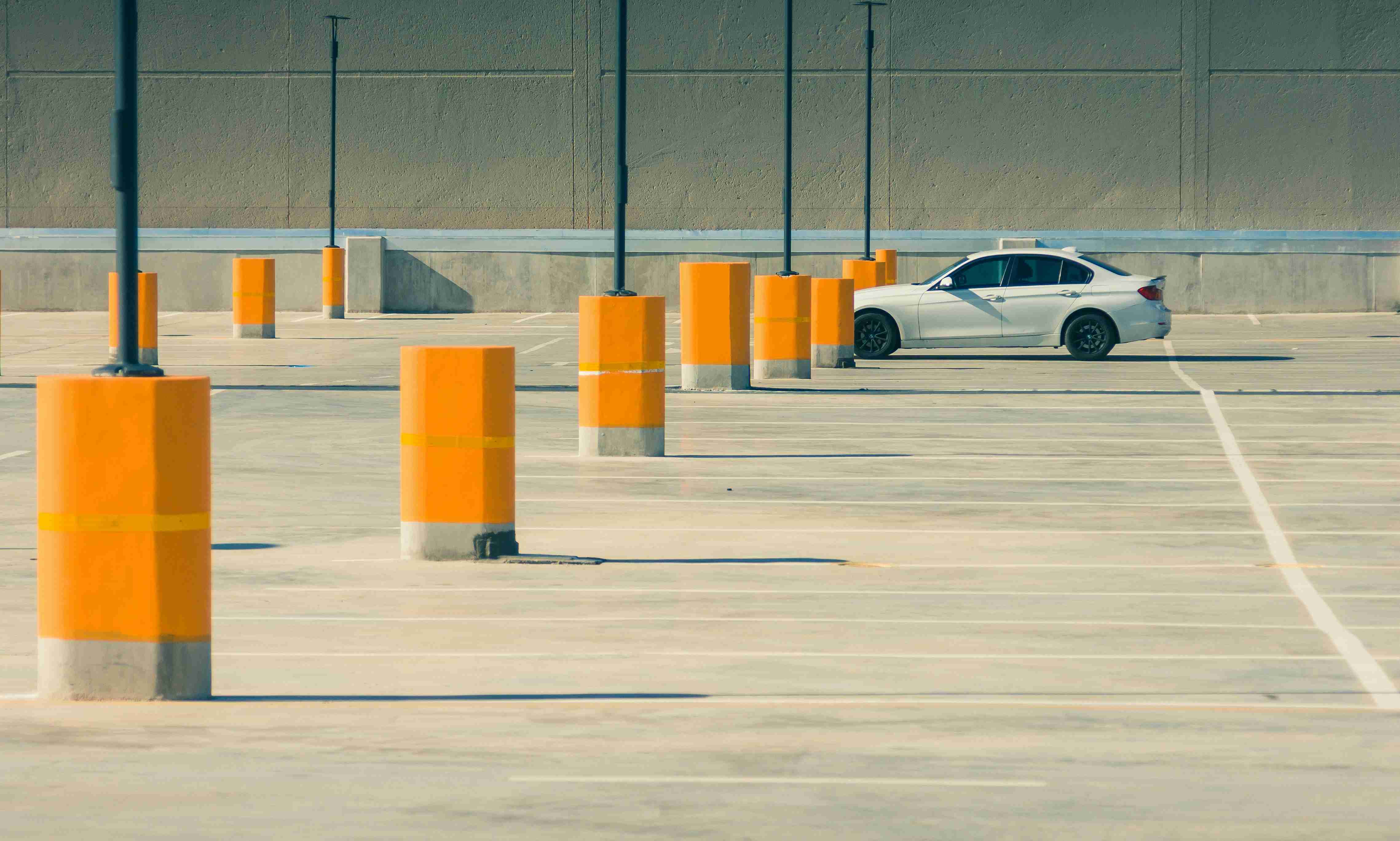 A white car on an empty parking deck.
