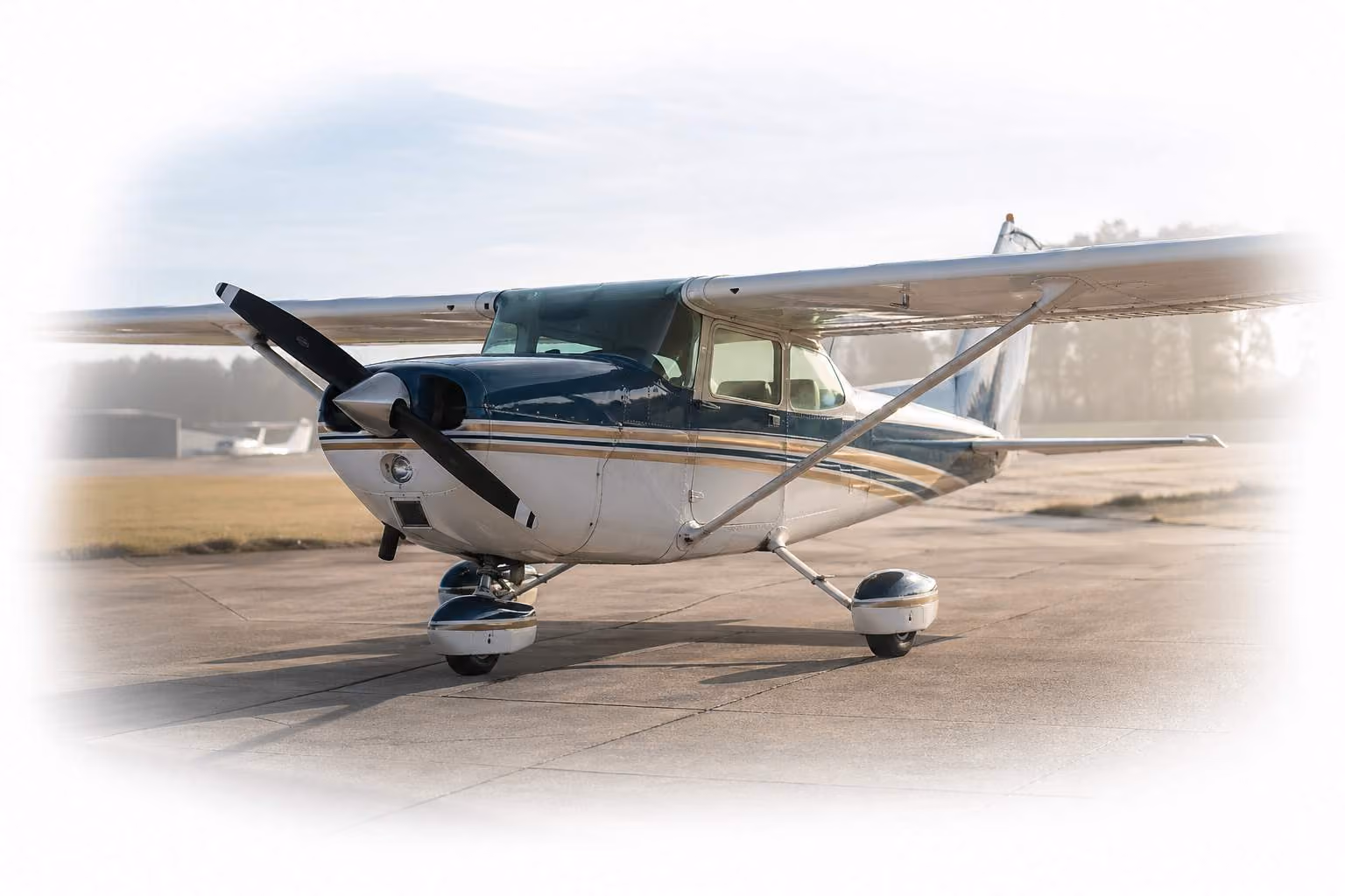Aircraft parked on a general aviation ramp, sunlit morning