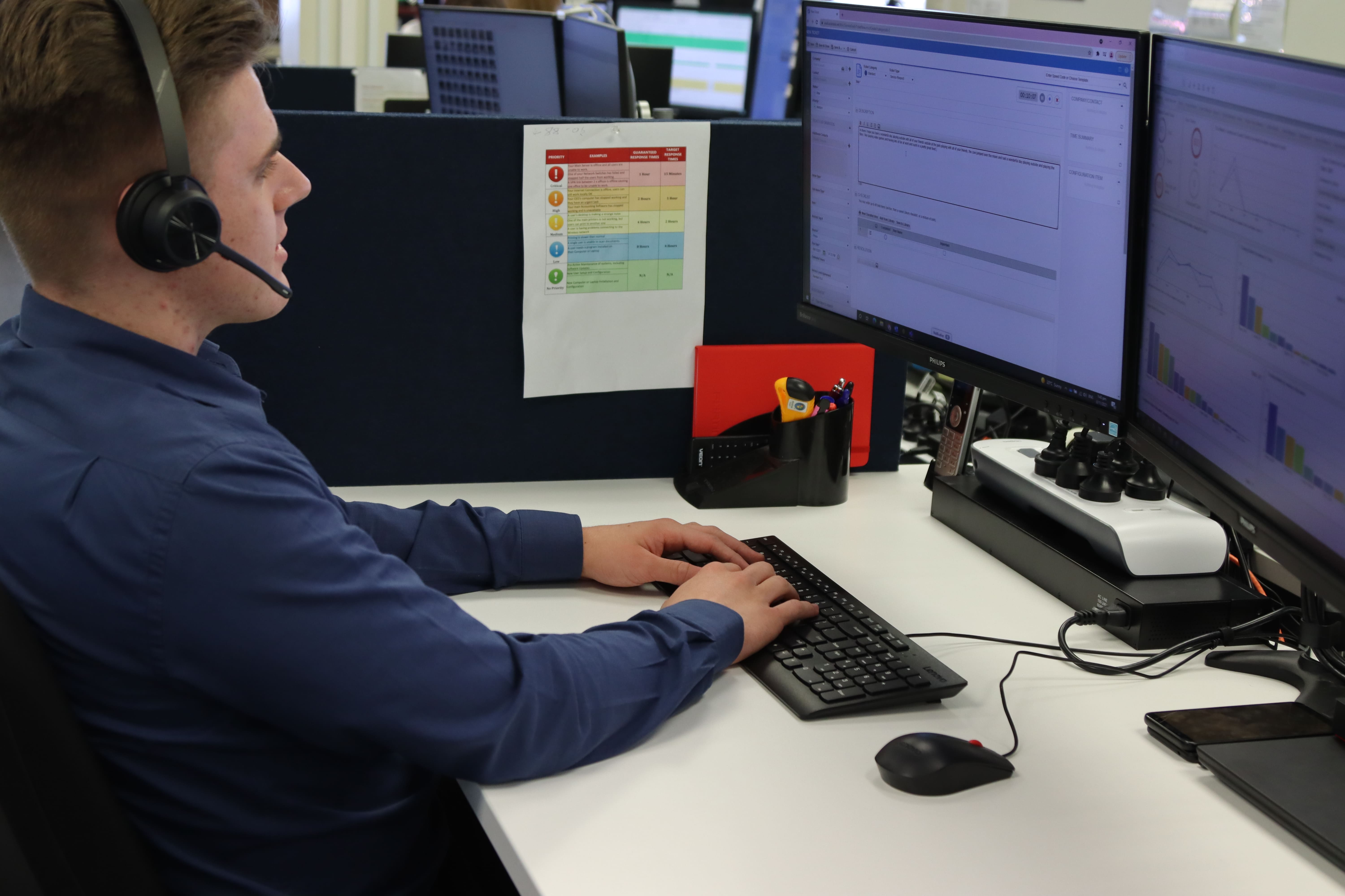 Aiscorp staff member working at their desk