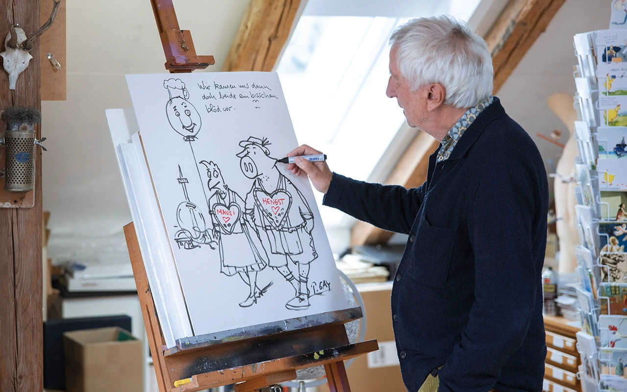Cartoonist Peter Gaymann zeichnet an einer Leinwand