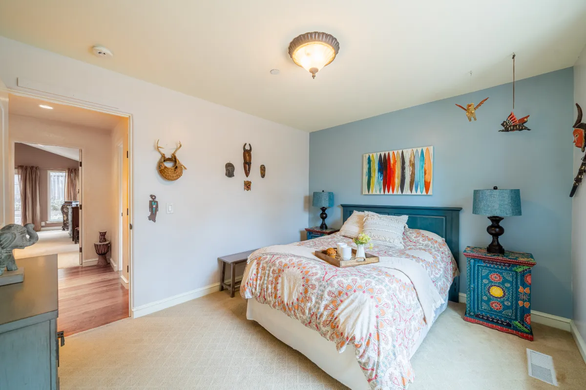 Wide photo of the second bedroom, subtle blues and adventurous feel.