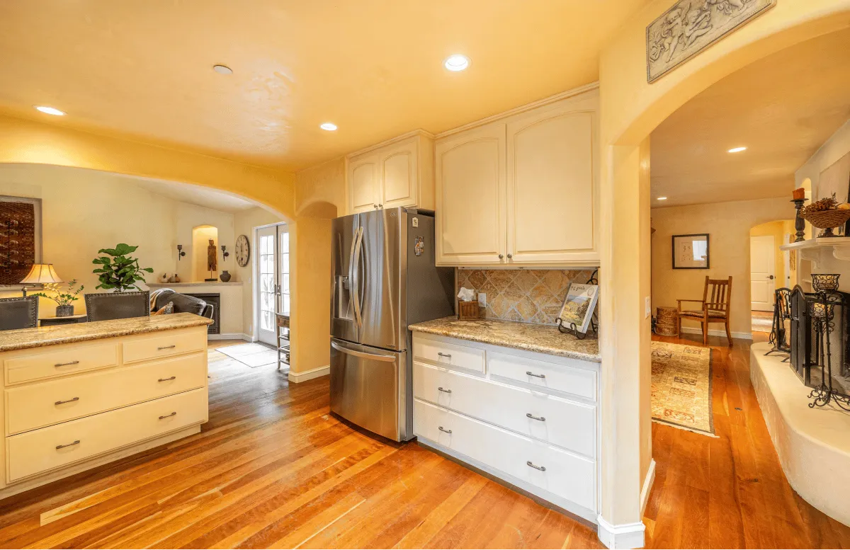 A view of the kitchen looking out into the living room and the family room.