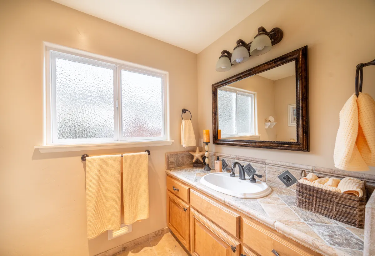 The second full bathroom with warm tones and stone tiles.