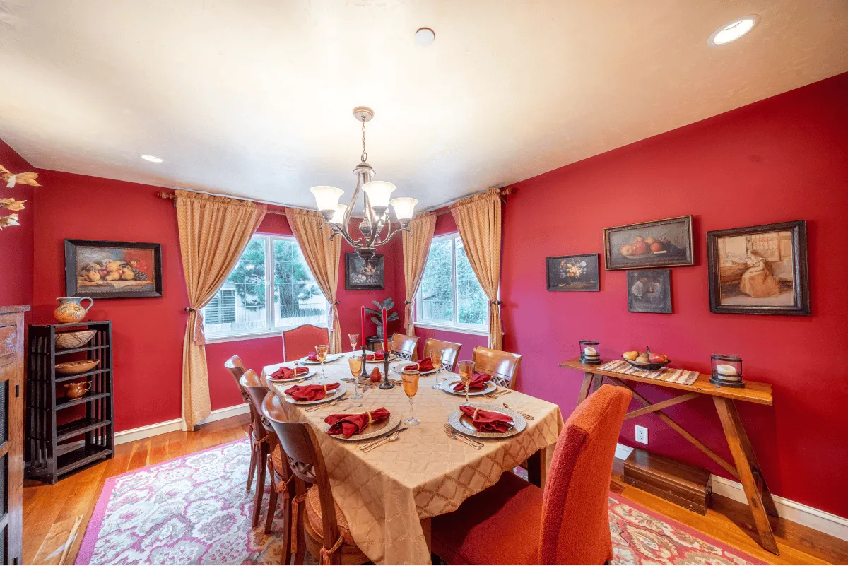 The deep red-painted dining room, for more formal and elegant occasions.