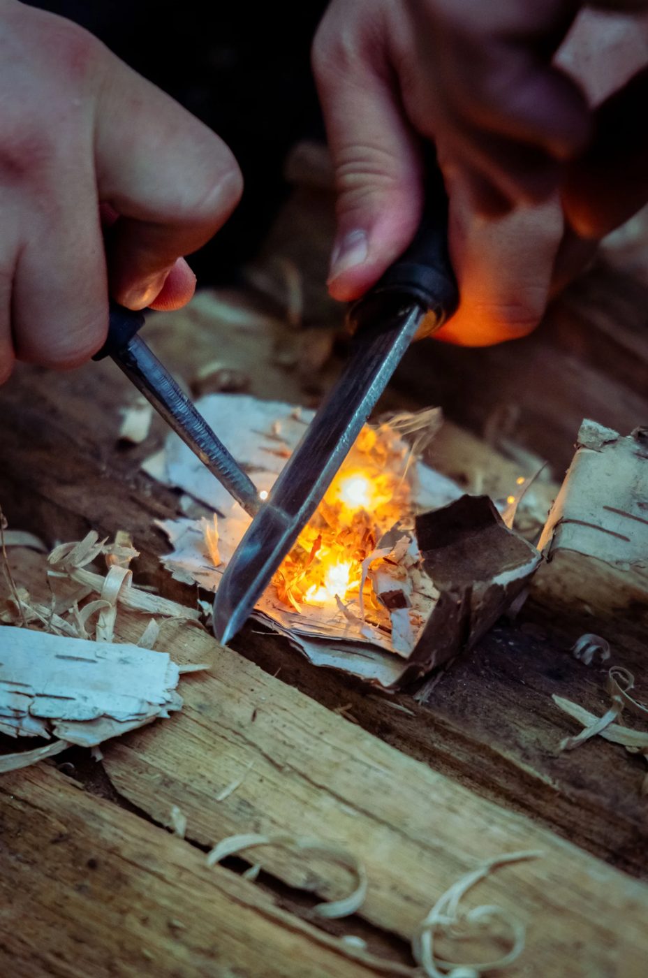 Striking a ferro rod to light birch bark tinder
