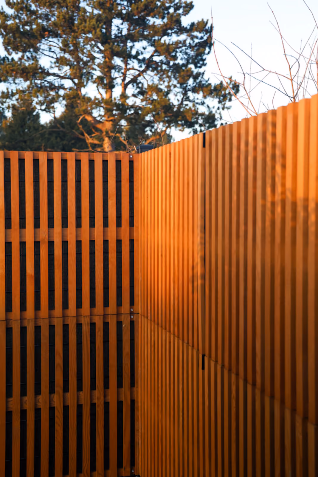 Noistop Essential acoustic fence with brown wooden cladding