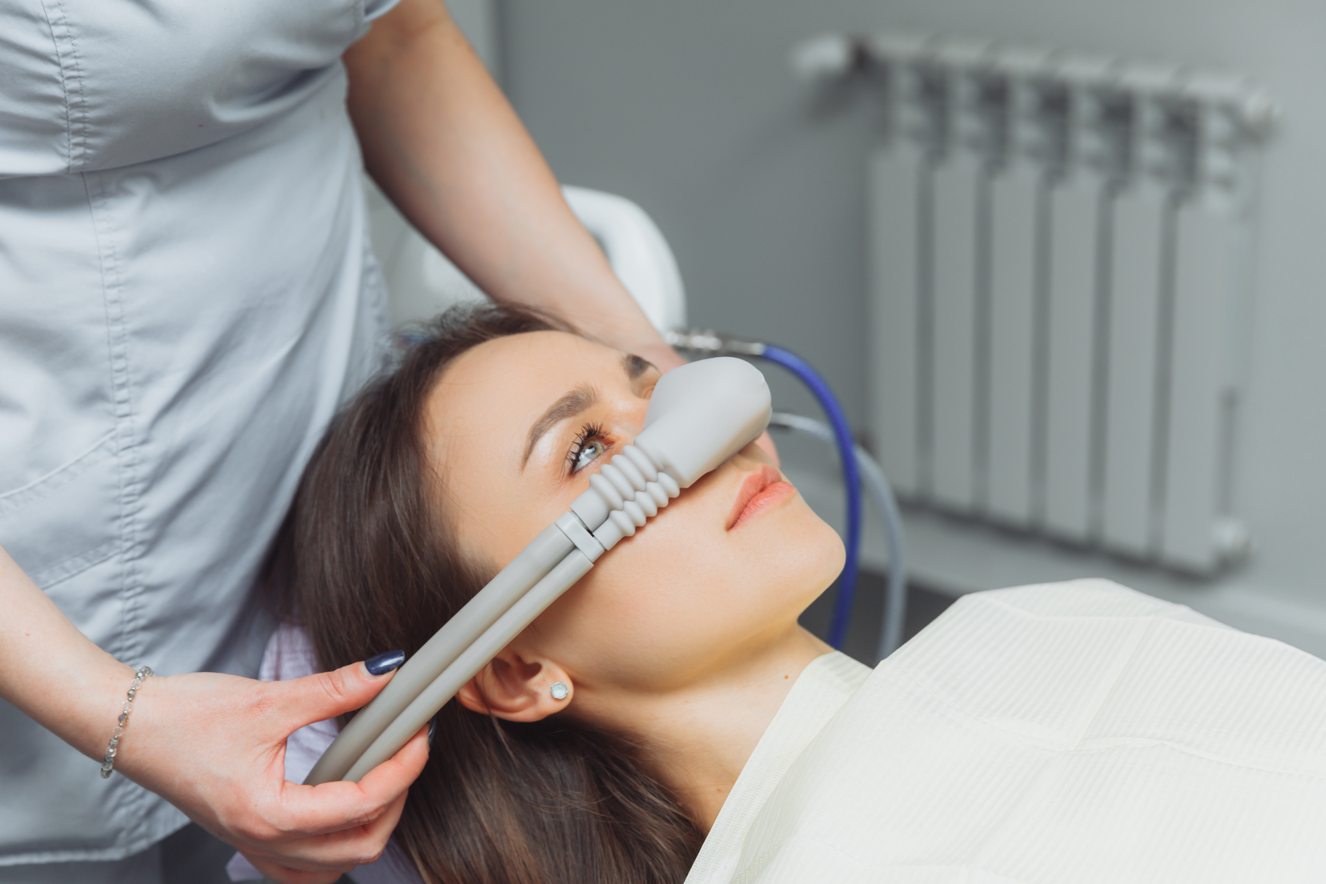 dentist puts inhalation sedative mask on his patient in Pasadena, CA