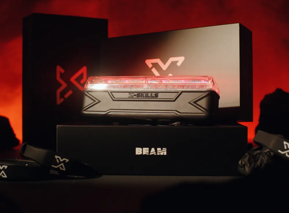 Productfoto van de X-Skills Beam met rood licht, geplaatst op luxe zwarte verpakking met rood verlichte achtergrond.