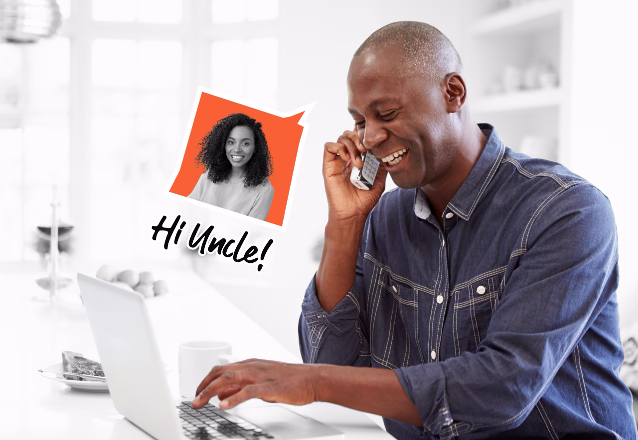 Smiling man talking on mobile phone while using laptop with a message overlay saying "Hi Uncle".