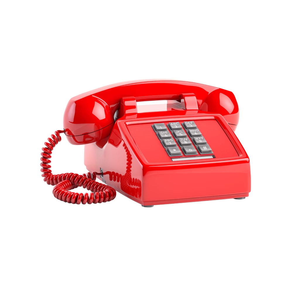 Red vintage rotary phone with a handset resting on top and a coiled cord.