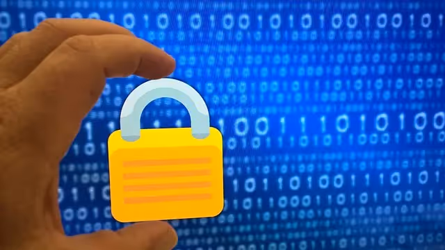 Hand holding a yellow padlock icon in front of a digital binary code background.
