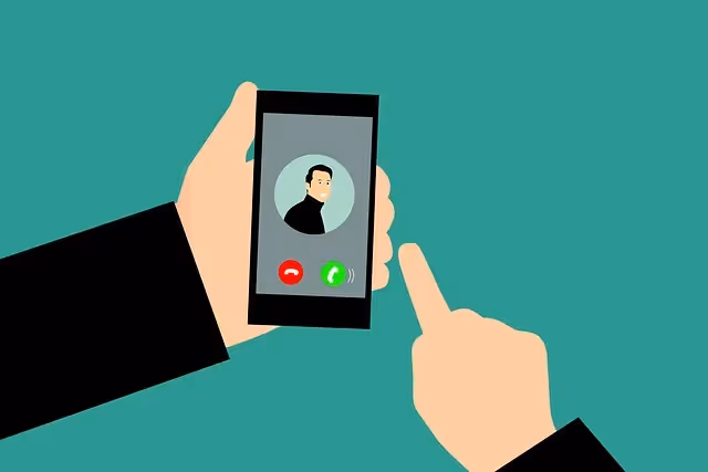 Person holding a smartphone showing an incoming call screen with a caller’s avatar and accept or decline buttons.