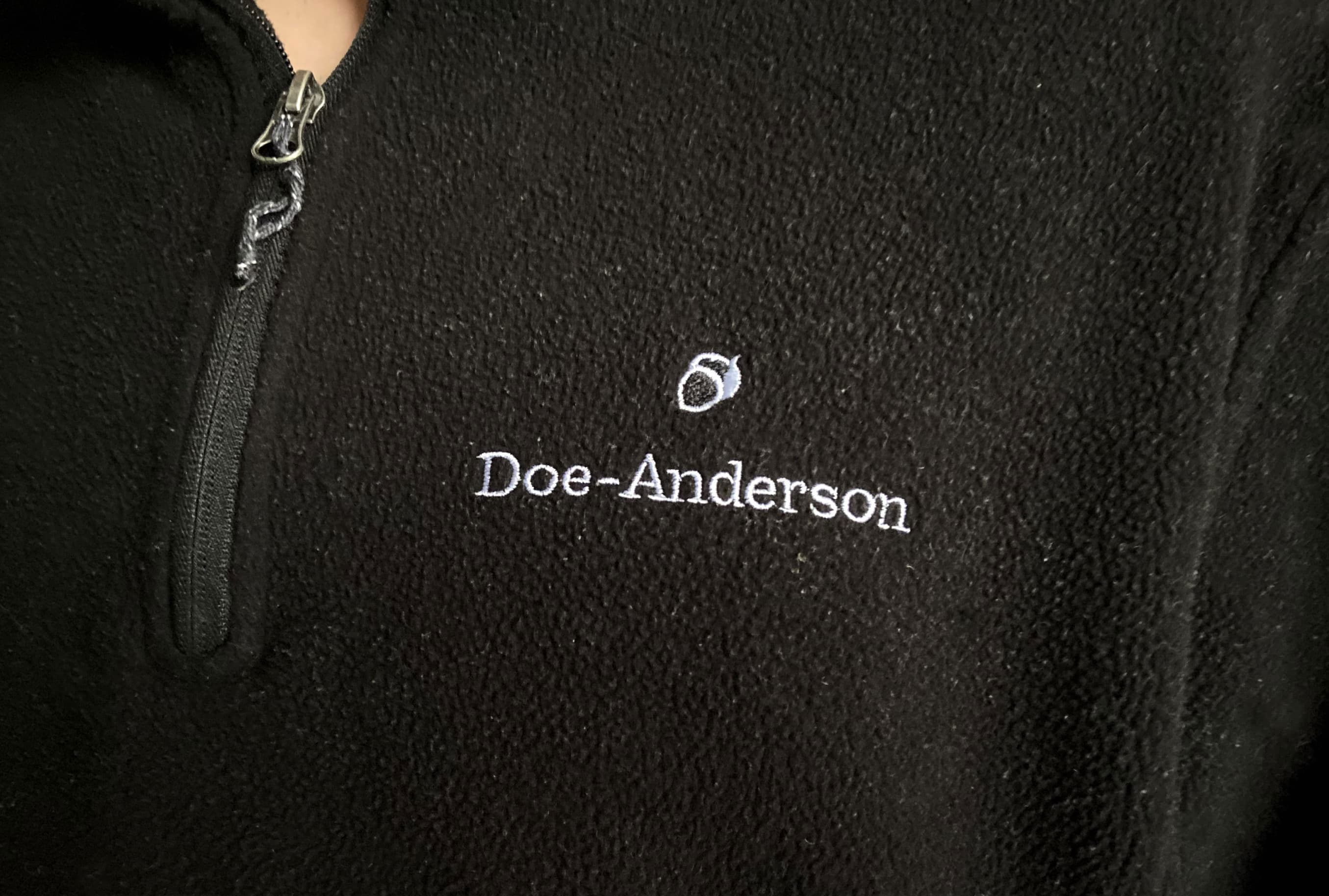 Doe-Anderson acorn logo on a black pull-over sweater.
