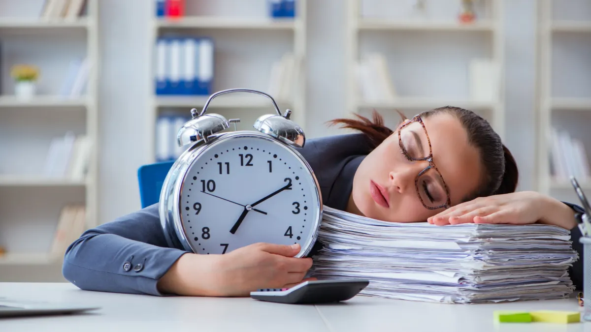 lawyer sleeping on a stack of legal documents, holding a clock