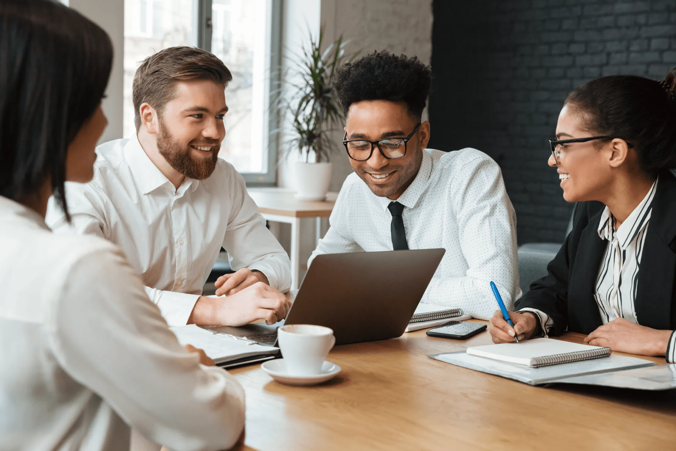 A group of lawyers using Smokeball around a conference table