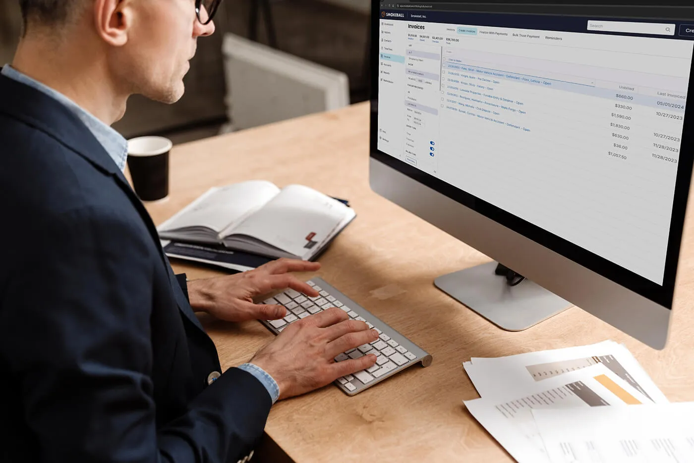 Man works on an invoice in Smokeball's billing platform