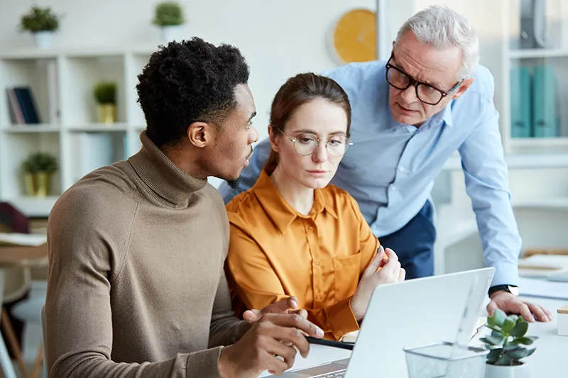 Team of lawyers look at laptop screen