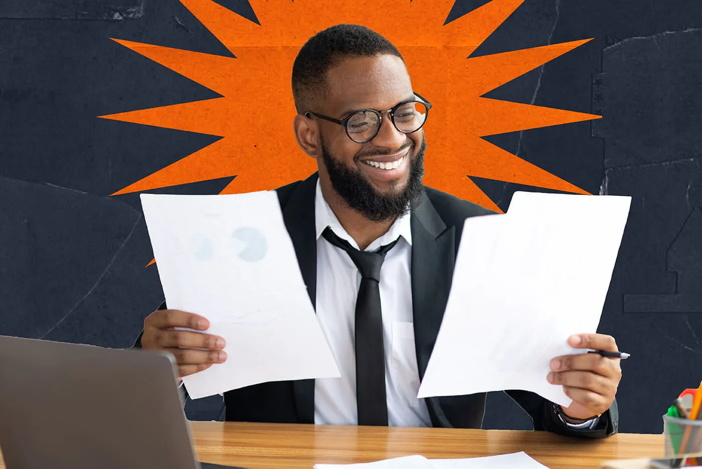 A man wearing glasses and a suit holds papers with some charts and statistics on them