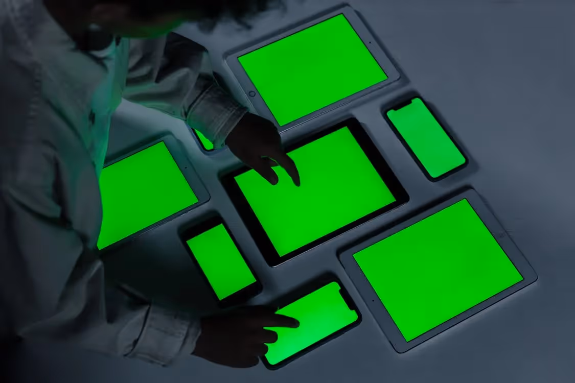 Free Blackskined man using smart phones and iPads Stock Photo
