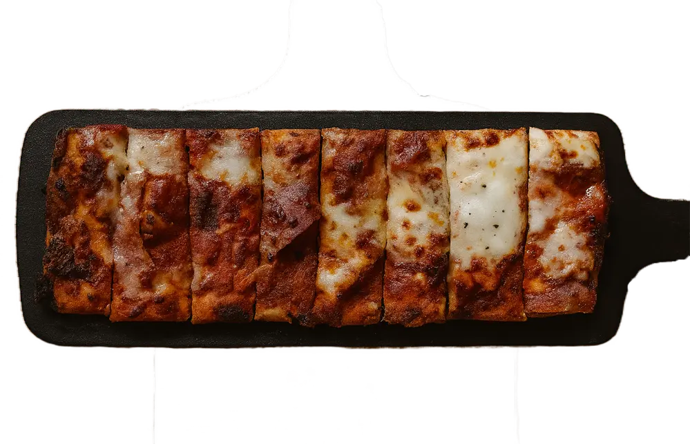 Rectangular focaccia bread topped with melted cheese, cut into eight pieces on a black serving board with a handle.
