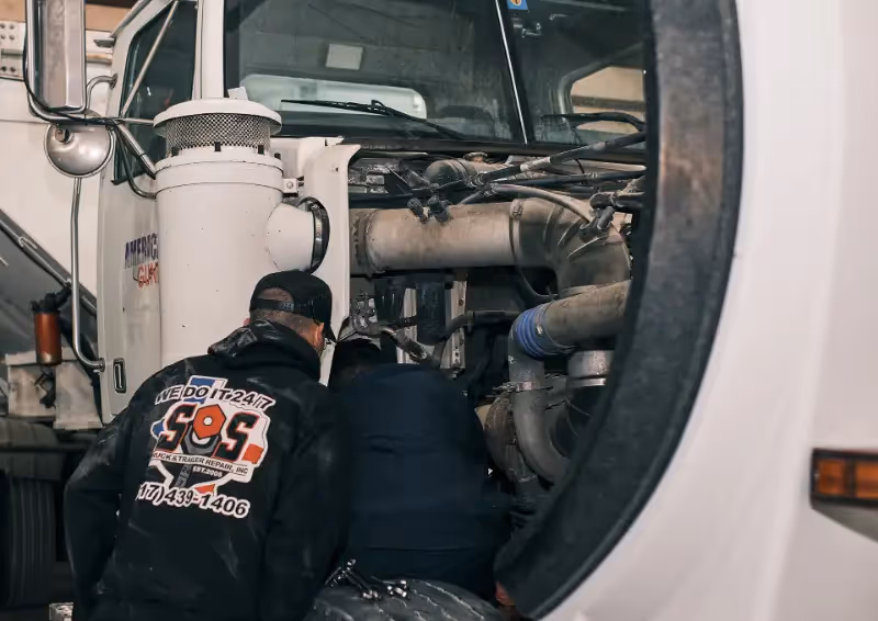 Mechanic performing roadside assistance services from SOS Truck & Trailer Repair