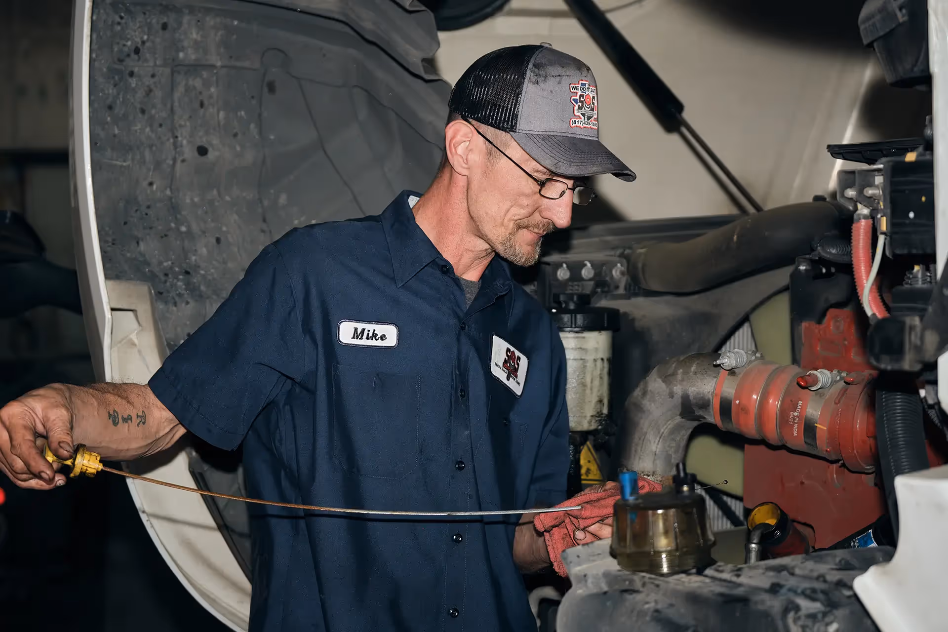 Mechanic performing truck Oil & Fluid service from SOS Truck & Trailer Repair