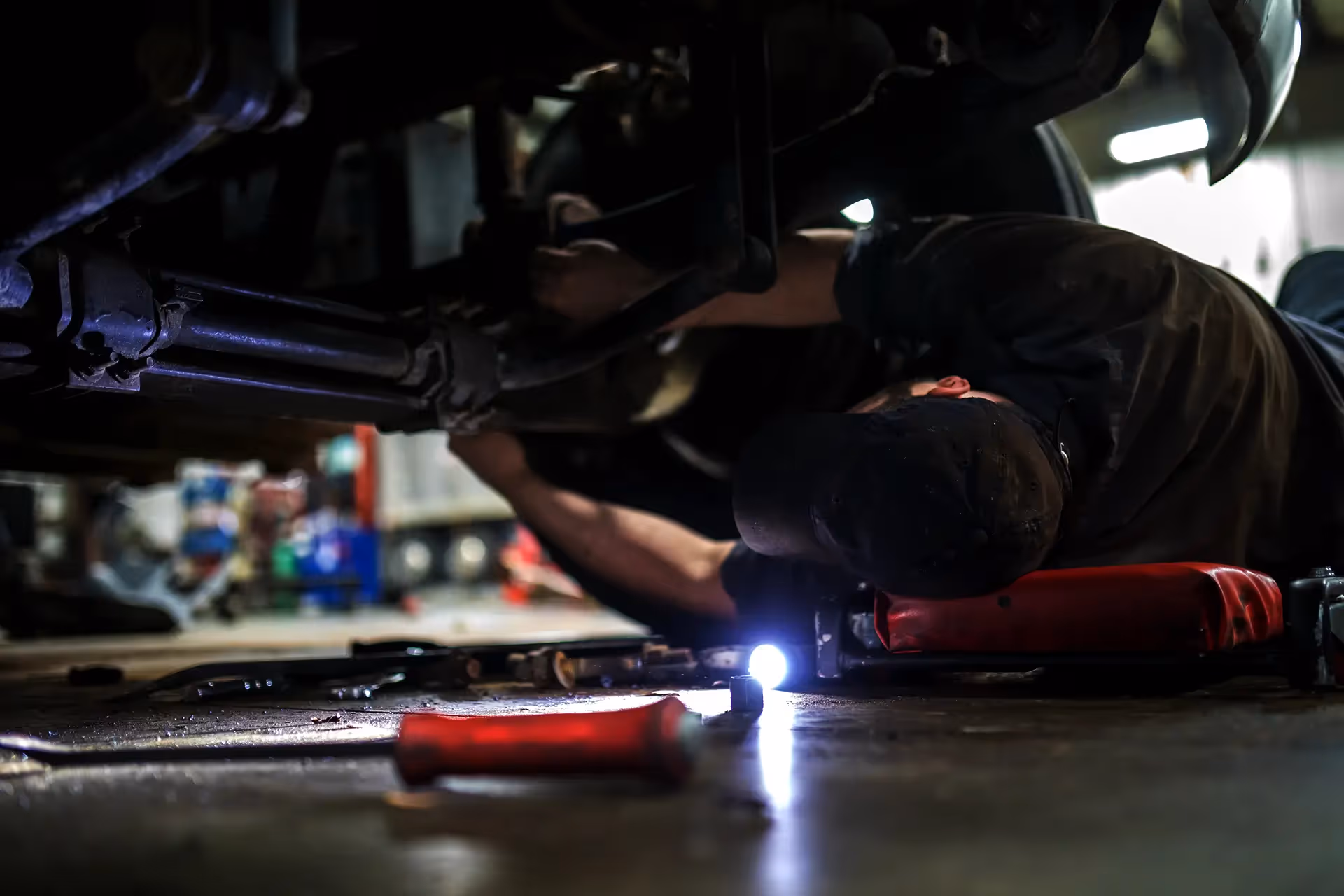 Mechanic performing truck driveline repairs from SOS Truck & Trailer Repair